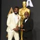 Actor Tarell Alvin McCraney and director Barry Jenkins, winners of the award for best adapted screenplay for Moonlight, pose in the press room at the Oscars on Feb. 26, 2017, in Los Angeles.